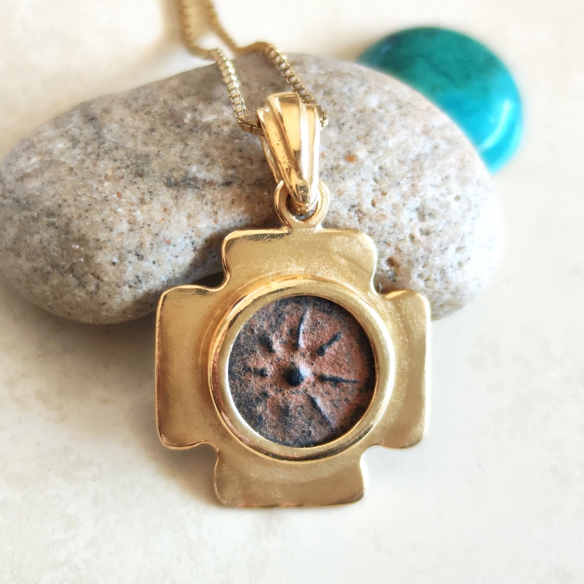 A cross-shaped gold plated pendant necklace set with a real antique Widow's Mite coin